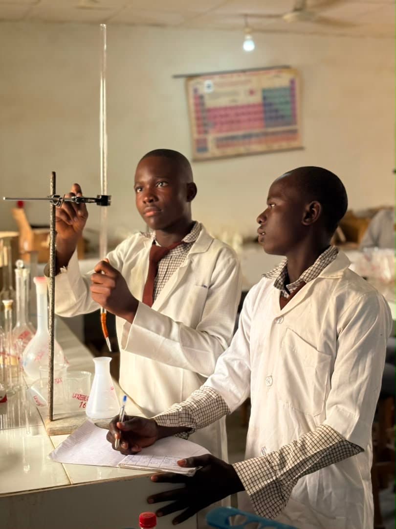 Students reading a measuring cylinder in the chemistry lab