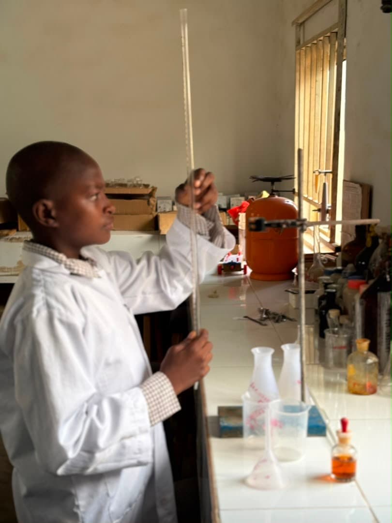 Student measuring liquid in a graduated cylinder
