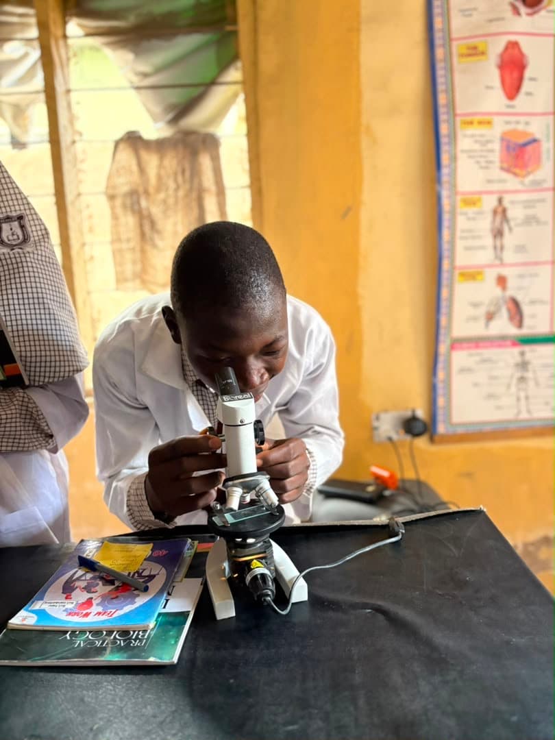 Student focused on microscope work